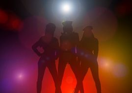 silhouettes of women on the dance floor