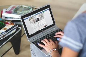 woman typing on a laptop