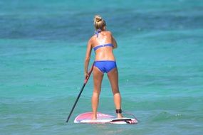 paddling woman in blue bikini