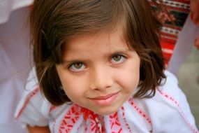 eyes of child dressed in the traditional costume of a peasant woman