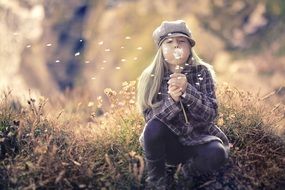 little girl with dandelion in the autumn forest