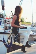 blonde girl woman boat marina white pants