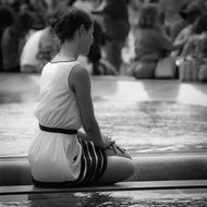 woman sitting near the louvre museum in paris