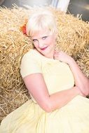 Smiling young woman in Yellow dress hay autumn