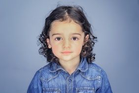 Portrait of the small girl with the curly hair