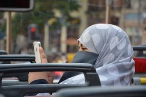 Woman with phone in arabic headwear