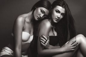 black and white photo of two sexy models