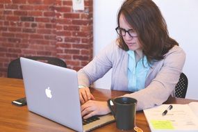 female office worker typing on laptop