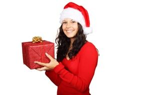 Happy woman holds a christmas box