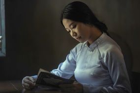 asian woman reading a book