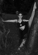 black and white photo of a ballerina in pointe on outdoors