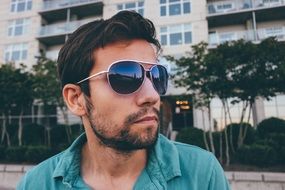 Handsome young man model in dark sunglasses