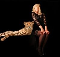 woman and cheetah in a dark