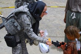 child gives a soldier a gift