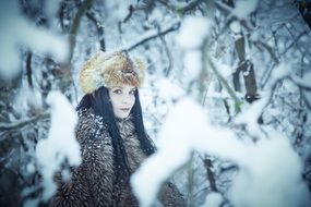 fashionable model in winter forest