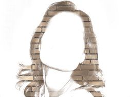 drawing of a female face on a brick wall