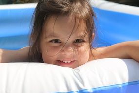 laughing girl in inflatable pool