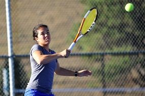 Woman tennis player with racket on court