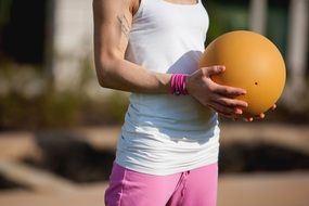 strong female hands holding a ball