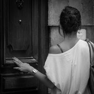 monochrome picture from the back of a girl with a bare shoulder