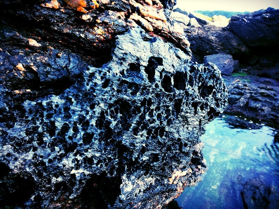 hole holes rock grey beach coast