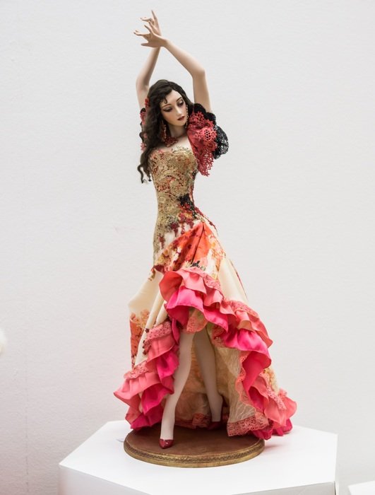 porcelain doll of spanish woman on white background