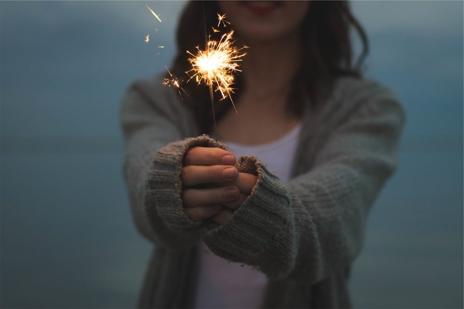 girl holds sparkler