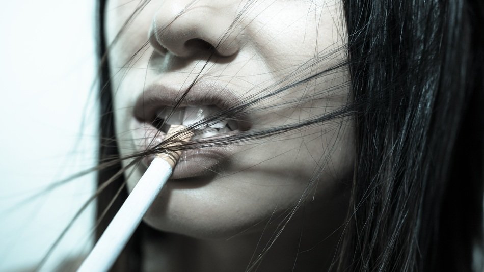 cigarette at lips of young girl