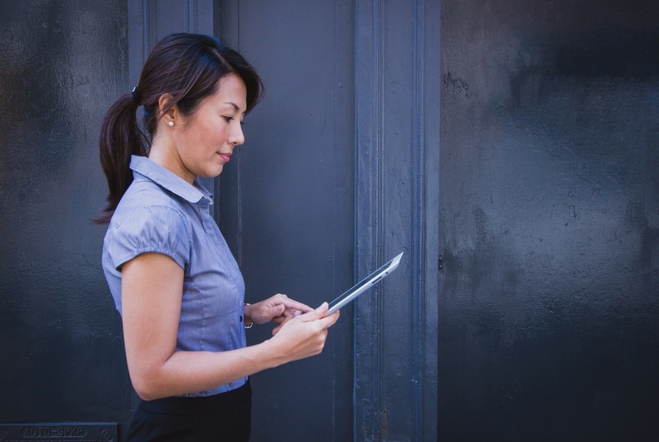 woman with tablet in hands at office