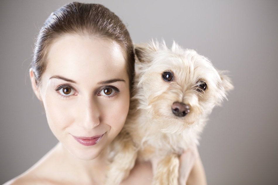 smiling young woman with little dog