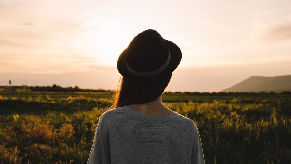 woman looking at a field in the countryside