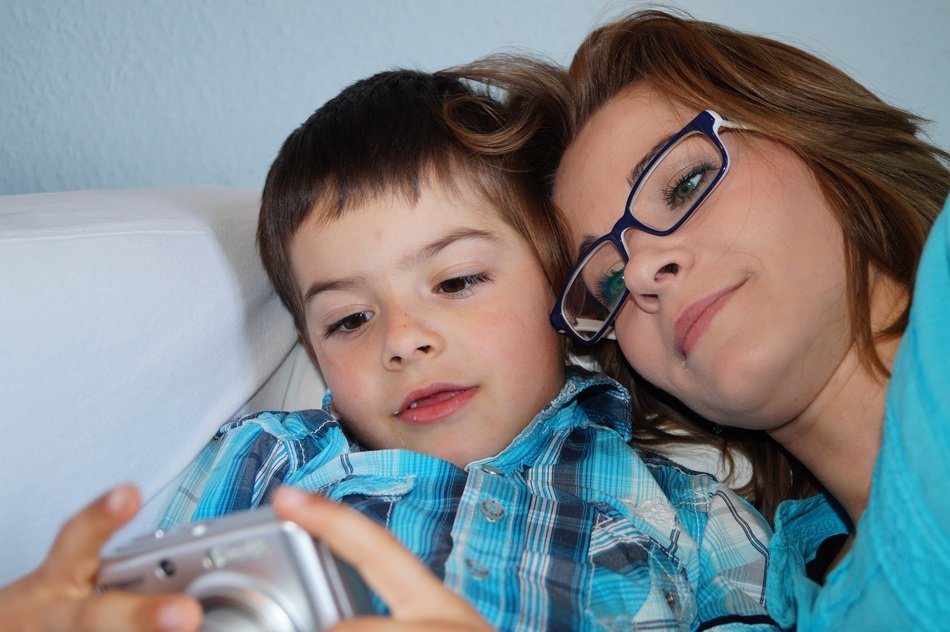 mother and son having a look on pictures in camera