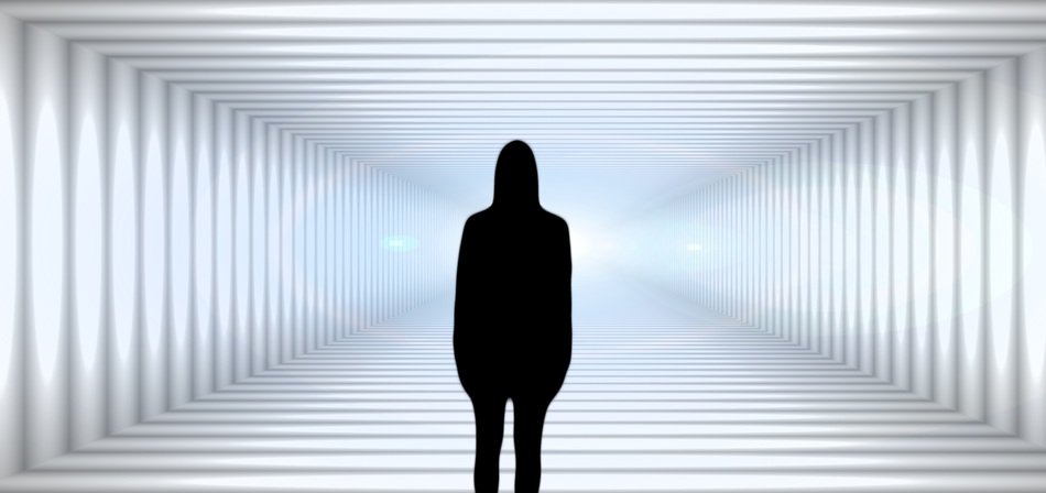 silhouette of woman looking into tunnel
