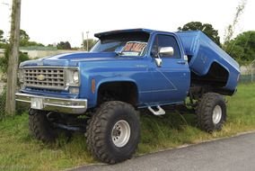 blue Chevy 4x4 truck on green grass as a picture for clipart