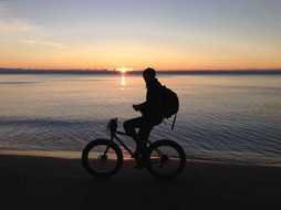 Picture of riding on a bike man on a beach
