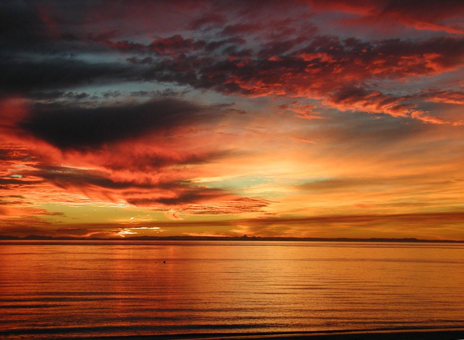 Beautiful sunrise in the clouds on the water