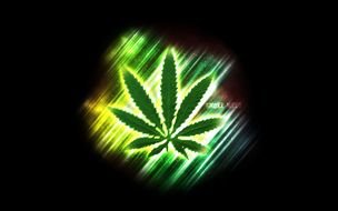 drawing of a green leaf of hemp on a black background