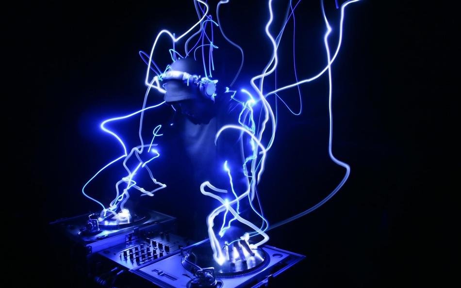 DJ at work in wires of blue light