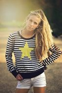 girl in a striped sweater with a star