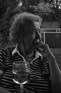 black and white portrait of an old woman in a restaurant
