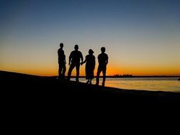 people silhouettes at the sunset