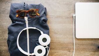 sweatshirt, sunglasses, headphones and laptop