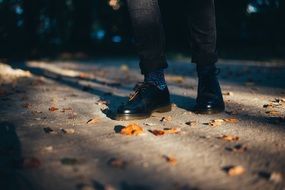 hipster‘s feet in stylish socks and black shoes