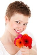 portrait of a girl with a bouquet of red flowers