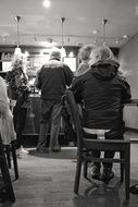 Black and white photo of humans in coffee shop