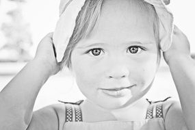 small girl in a hat in black and white