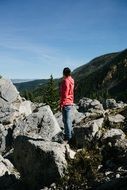 girl stands on stones