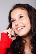 Smiling girl calling the telephone