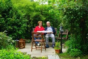 Adult couple man woman sit rest Green garden