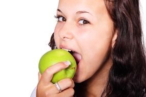 brunette is eating a green apple